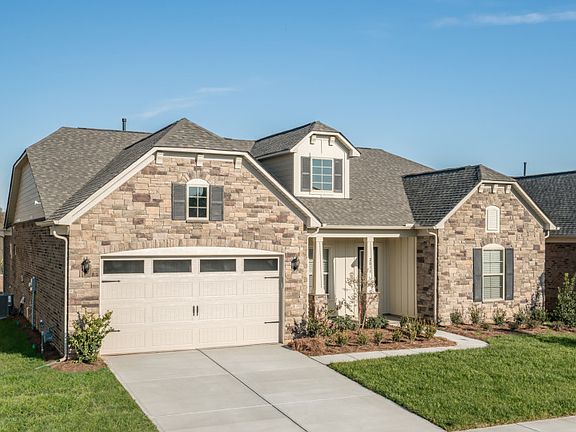 Tangerly Oak Exterior EC3S features stone, hardi board and covered front porch