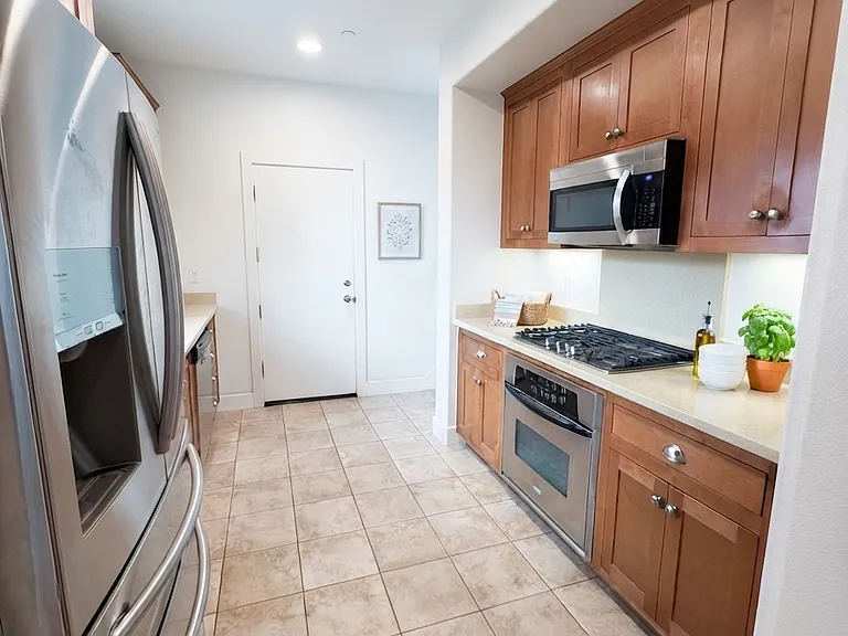 Well-appointed kitchen featuring stainless steel appliances, ample cabinet space, and abundant natural light