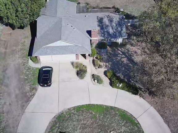 Three car garage with plenty of parking