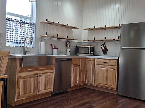 Brand new hickory kitchen cabinets, Bosch dishwasher, custom tile countertops and backsplash.