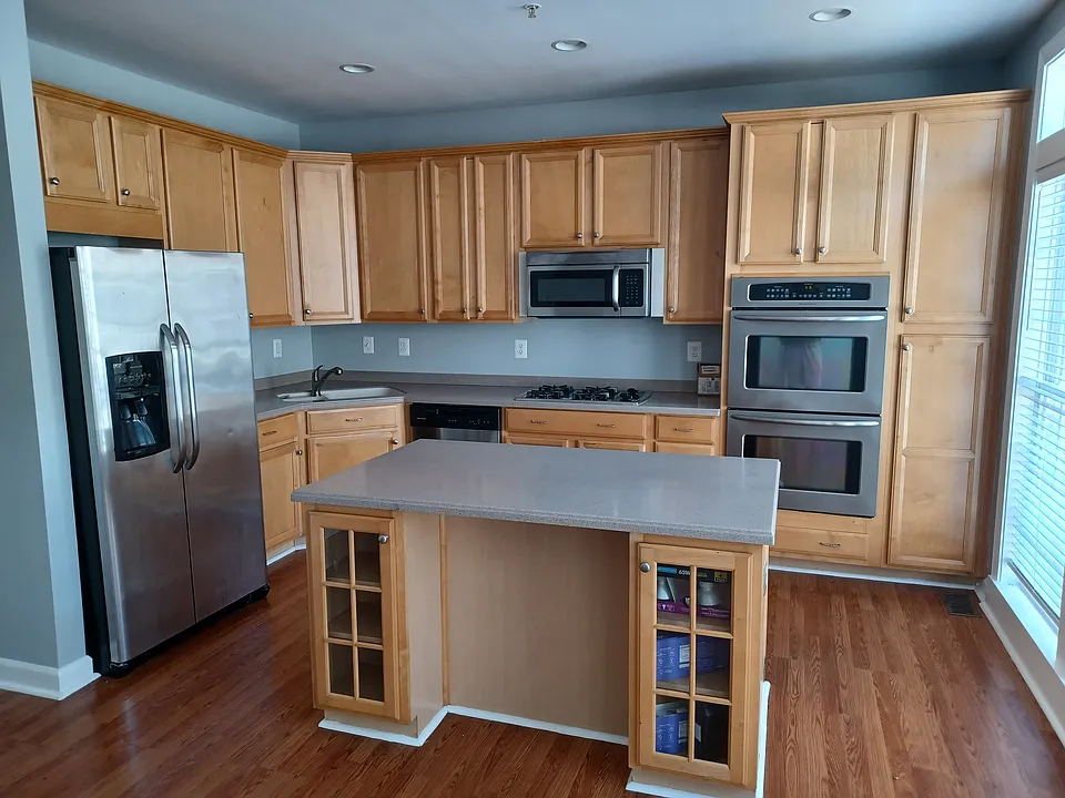 Eat in kitchen with side by side fridge/freezer, double oven and island, access to deck, freshly painted