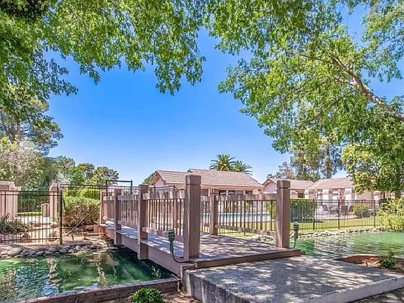 view from villa towards fenced in pool and clubhouse area