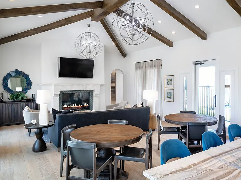Resident lounge with multiple seating areas and a fireplace