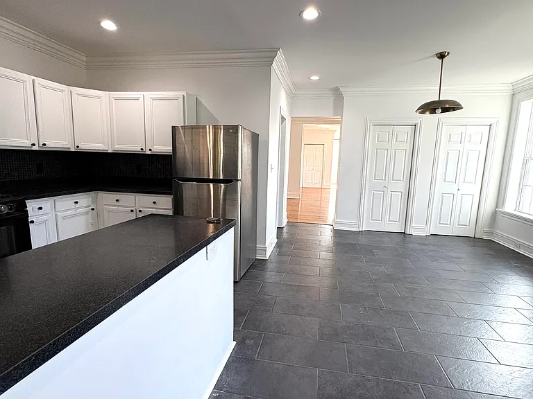 1st Fl - Kitchen (l) with Dining Room (r) and closed double pantry closets (c)