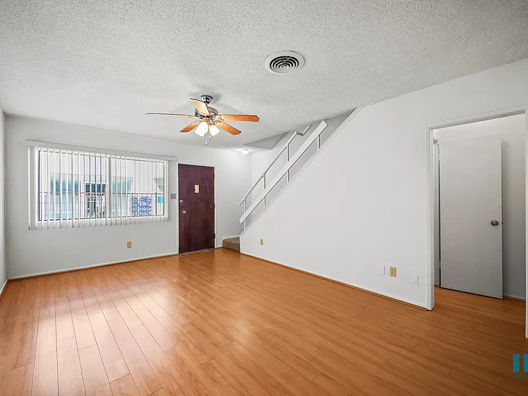 Entryway and Living Room with a Stairwell to the Upper Level of a Townhome