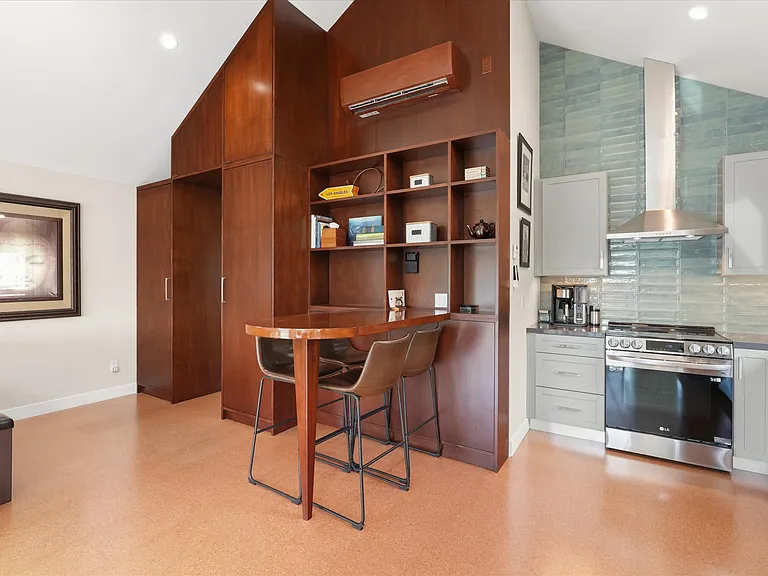 Custom walnut built-in shelving and bar area.
