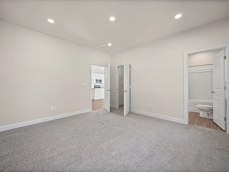 Master suite with a private bathroom and a walk-in closet