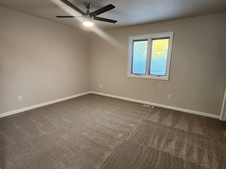 Primary bedroom has walk-in closet with Elfa closet system.