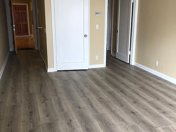 Living room, the entry on left, walk-in storage center, and small hallway to bathroom and bedroom.
