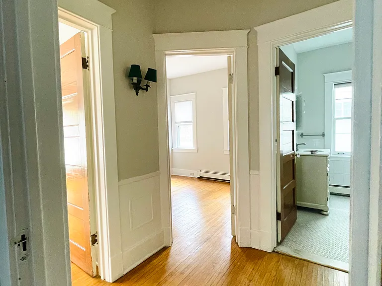 Common hallway where all three bedrooms branch off of into separate spaces.