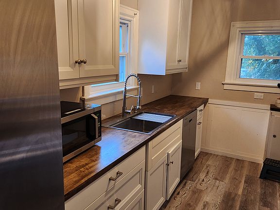 Kitchen with updated cabinets, fixtures, flooring and appliances