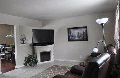 Living room is perfect for TV and adjoins kitchen.  Tile floors!  Easy maintenan