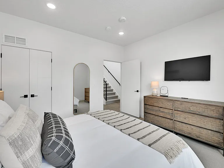 Second downstairs bedroom with queen bed and smart tv