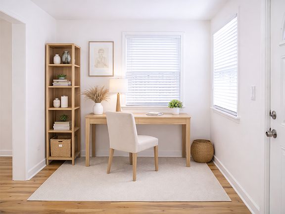 Staged as a home office to showcase the versatility of this light-filled front room with (3) windows