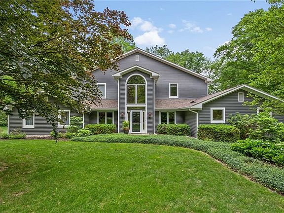 What was once a modest ranch home has been transformed into a spacious retreat nestled in the woods.  The exterior was painted by Rhinoshield and should last a long time! Nature abounds and perennial gardens surround the home.