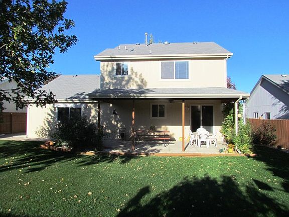 Fenced backyard, covered patio, sprinkler system front and back