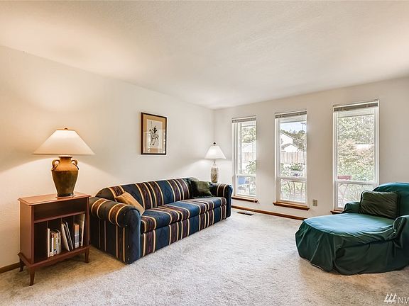 Large windows flood this formal living room with light