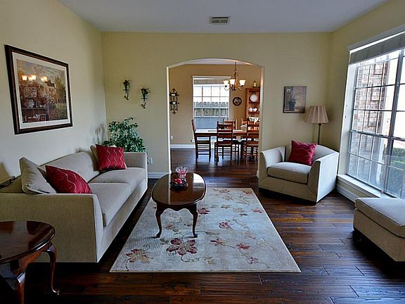 As you enter the home you are greeted by a beautiful formal living area open to the formal dining room.