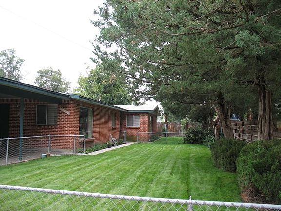 Access to unit through second shared (with front unit) fenced in yard off of carport. Lush vegetation, well manicured yard.