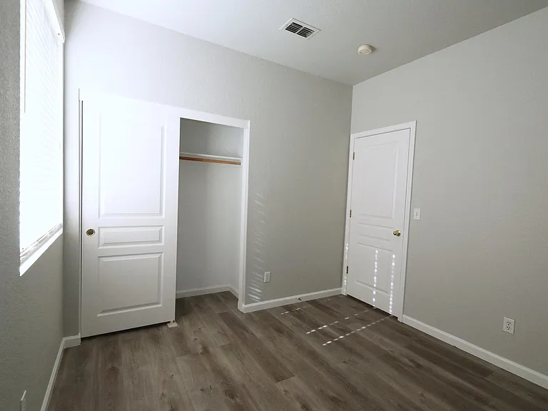 Bedroom #1 with recessed lightning, window blinds, and closet