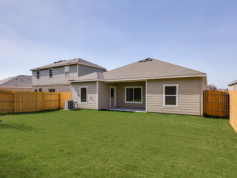 The back yard is fully fenced in.