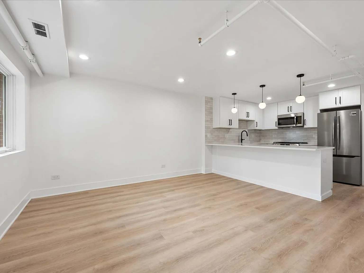 Bright Logan Square 2BR/2BA | Chef's Kitchen, In-Unit W/D, Balcony — Photo 4