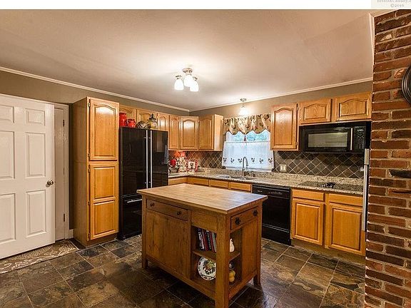 Kitchen features Granite, Island and slate flooring