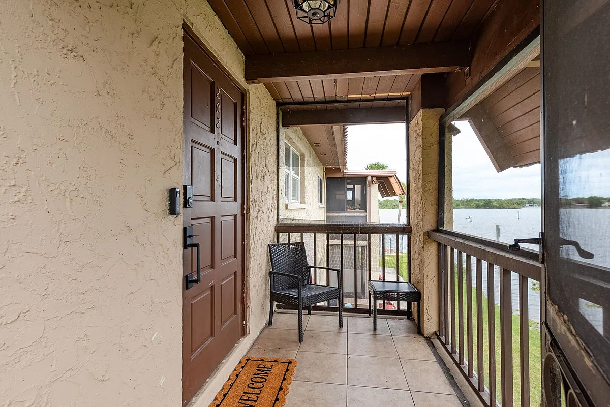 Front Patio - Screened in with Welcome mat and seating for one. - 1005 S Bayshore Blvd #202