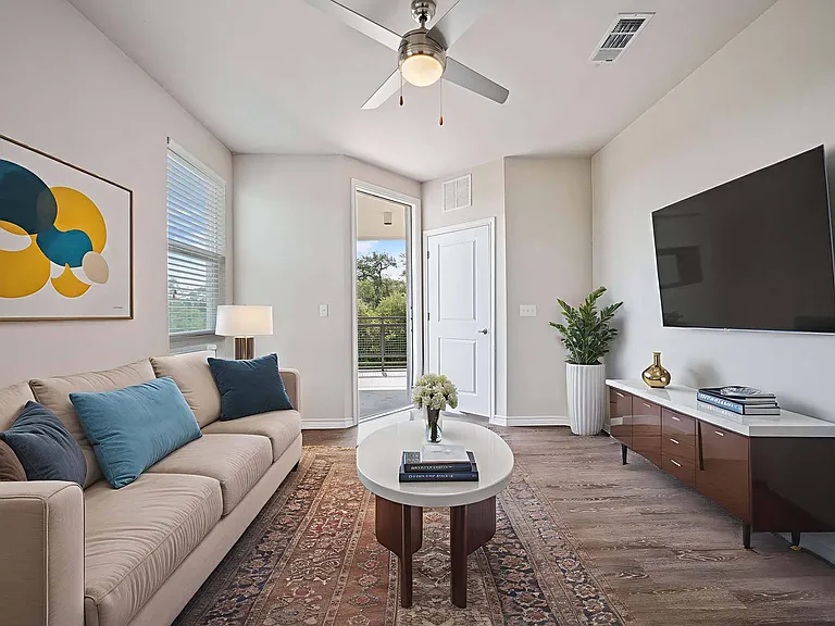 Step into your bright living room with easy access to a large private patio for indoor-outdoor living.
