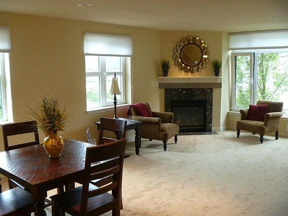 The living room has a cozy gas fireplace and plenty of west facing windows.