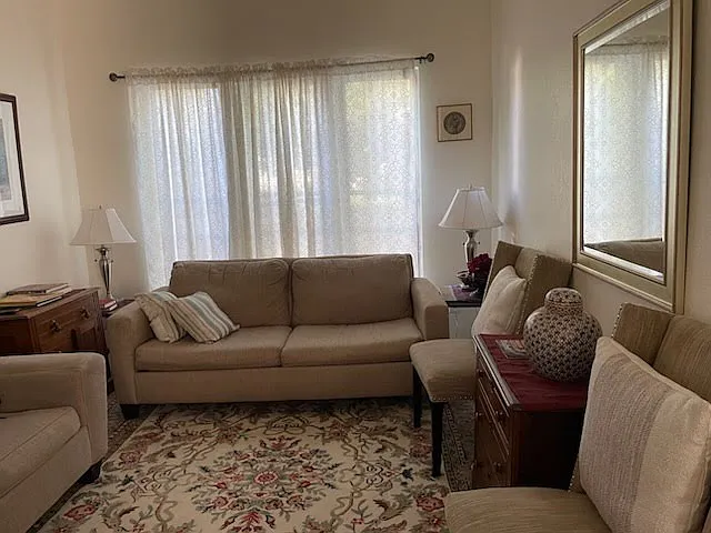 Gorgeous light, cathedral ceilings offer a gracious, spacious feel to this living room just off the entrance to this home.