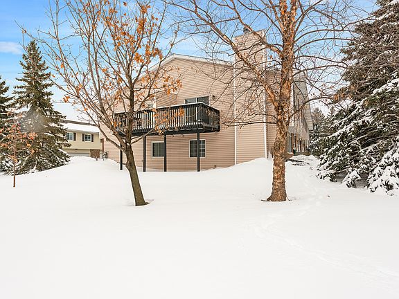 Deck overlooks green-space.