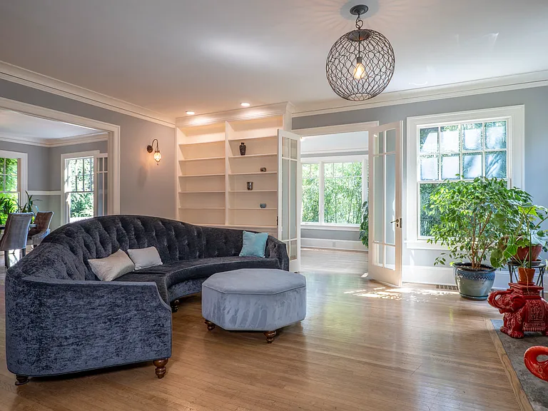 Huge living room with fireplace and large curved couch. TV comes down lower on an arm for ease of use. Tall 9'2" ceilings.
