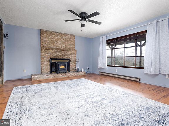 Living Room with Wood Burning Fireplace-Chimney recently repointed and has a Titanium Liner. Bay Window offers beautiful view