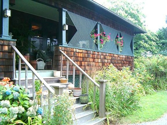 Front porch wraps south & east sides of home