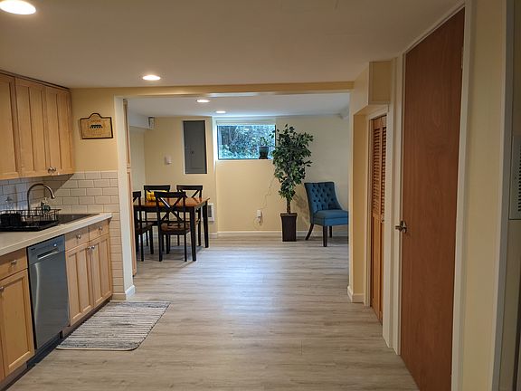 Kitchen looking into the dining space, door on right is a large pantry with shelving space.