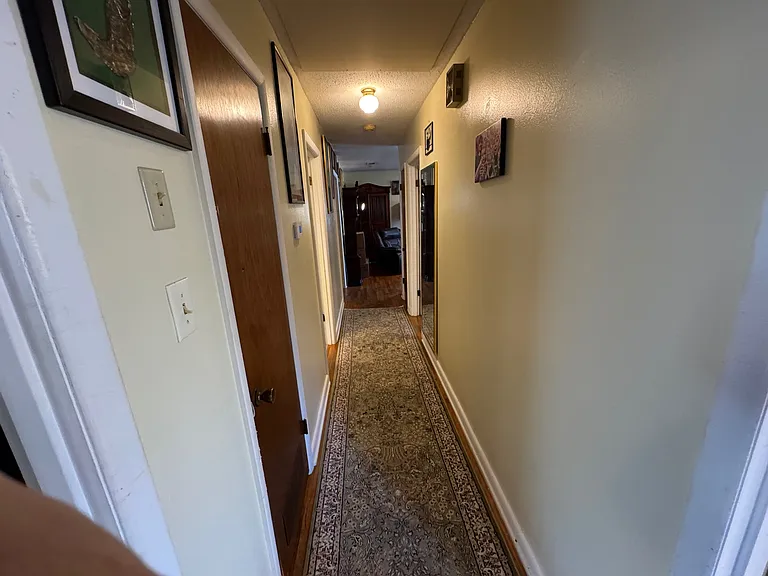 hallway with new central gas furnace at the end of the hall