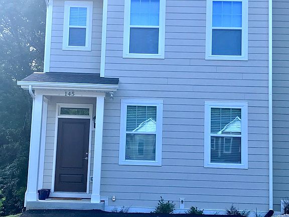 End unit, with tons of natural light. Peaceful woods behind.