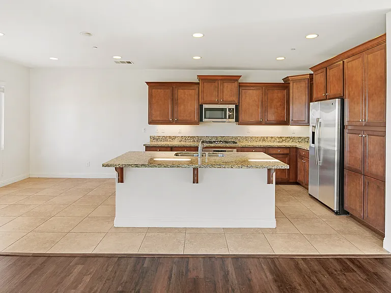 Kitchen with lots of cabinets, gas stove top, Dishwasher, Microwave and Side by Side Refrigerator Included.