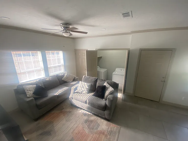 Living area with washer and dryer.