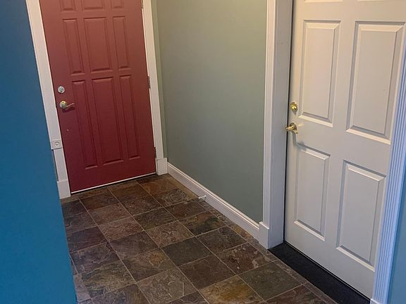 Entry to front door (red). Door to the right is to the single garage.