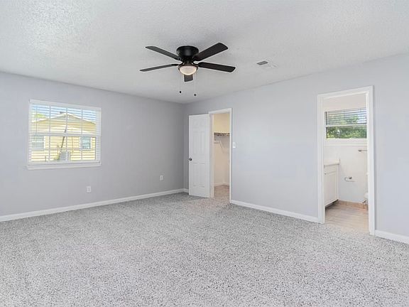 Primary bedroom with full ensuite bathroom, walk-in closet, and private entrance