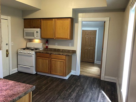 Kitchen view from living room. Room dimensions: 11x12. Back door leads to shared laundry in the basement and back yard storage.