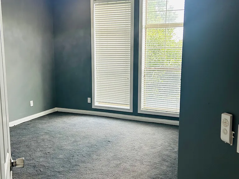 Bedroom#1 with high ceiling and window wall for plenty of light.