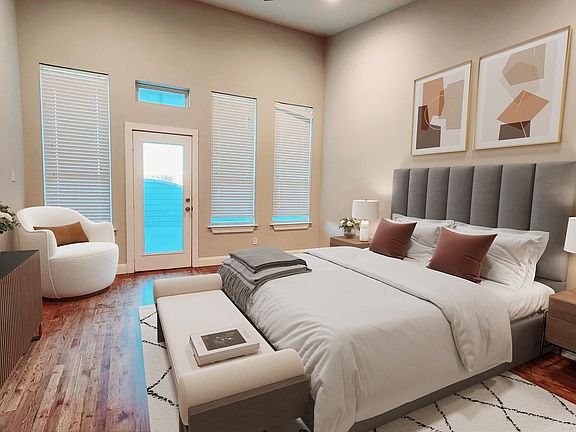 Primary bedroom has custom hardwood flooring, spacious walk-in closet, and on suite bathroom with tiled shower and double vanity with stunning quartz countertop.