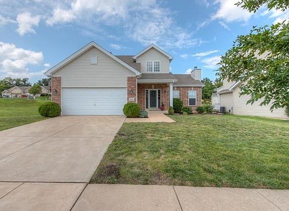 Partial brick front, vinyl siding, professionally landscaped.