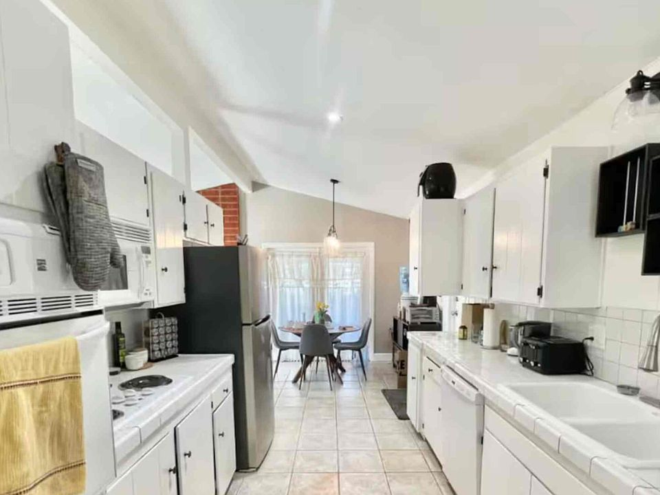 Full kitchen - new refrigerator (second refrigerator is in garage), dishwasher, oven, stove, plenty of spaces in cabinets for food, coffee nook, dining room connected