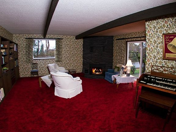 Living room with sunken gas fireplace.