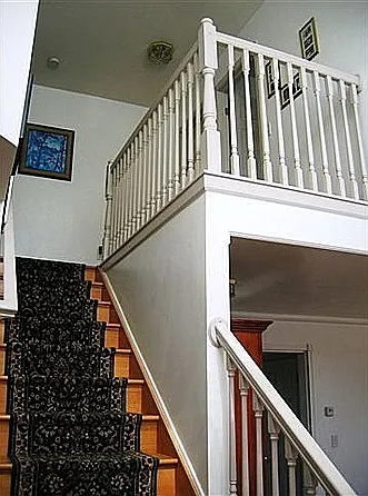 View of stairs from the first floor. The master bedroom is on the right of upstairs
