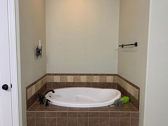 Master bathroom jacuzzi bath with TV mount